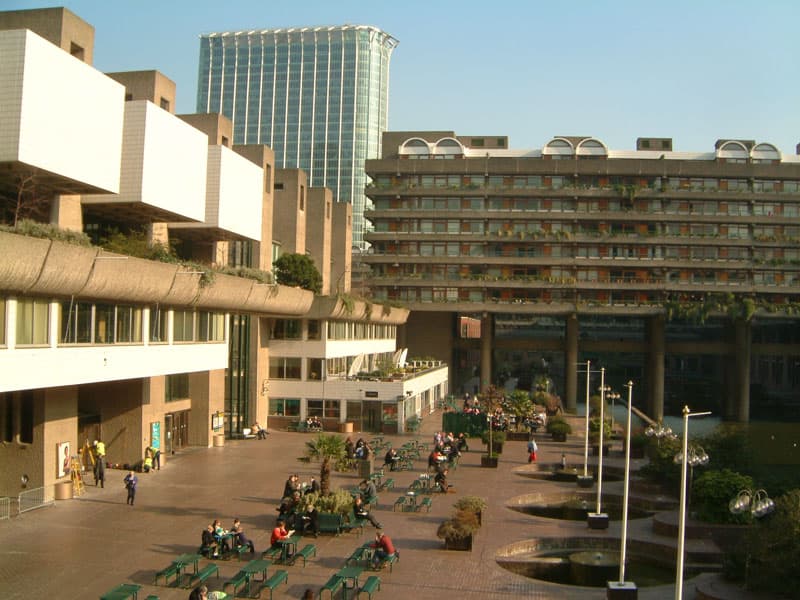The Barbican Centre in London, seen across its lakeside terrace on a clear day.