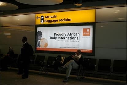 GTBank “Proudly African, Truly International” lightbox beside the Arrivals and Baggage Reclaim gantry at Heathrow.