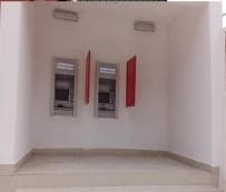 Branded surround framing a two-machine ATM alcove at the site.
